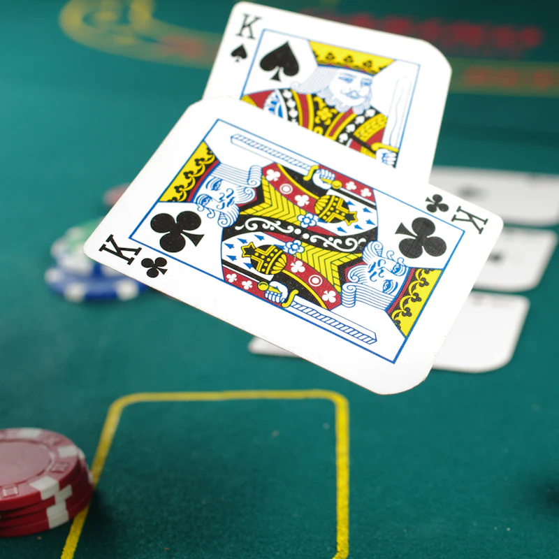 Playing cards on a green felt table in the Uvendra casino