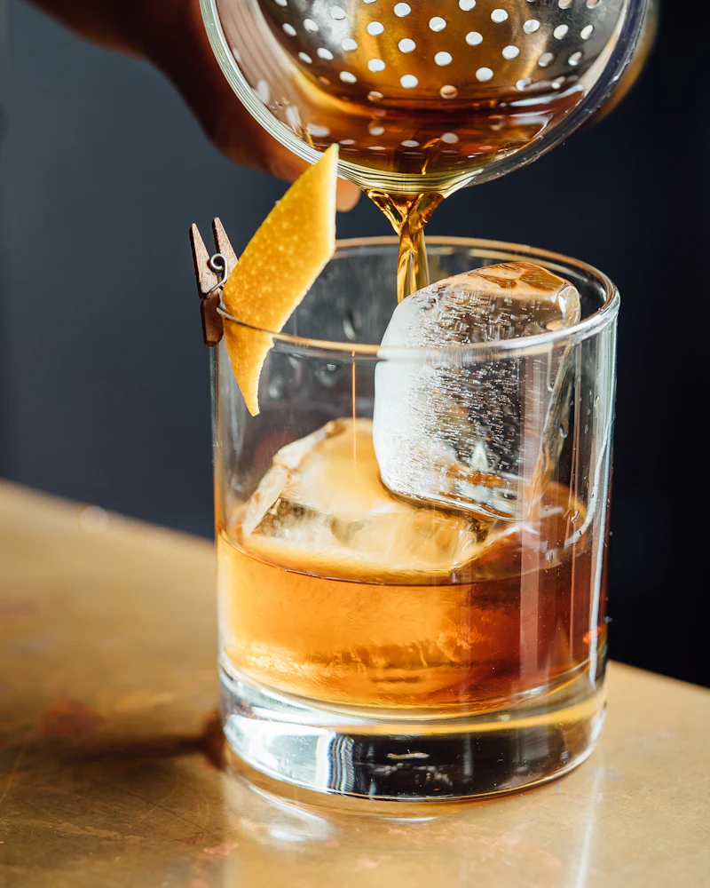 A drink being poured over ice at the Uvendra bar