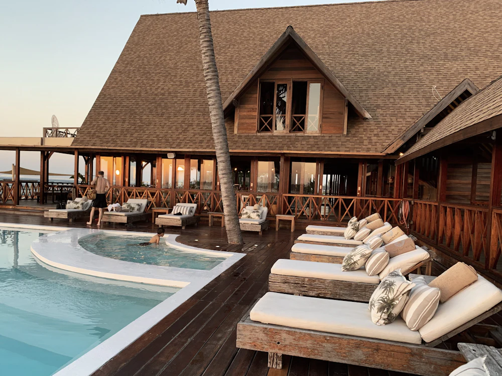 Uvendra pool with loungers beside a timber pavilion